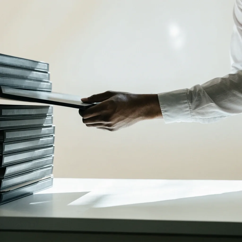 Blank policy pages fanned on a pale bench with wide empty margins visible around each sheet